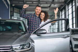 A happy couple who just bought a new car financed by DMC Finance