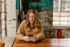 Happy woman looking at her phone
