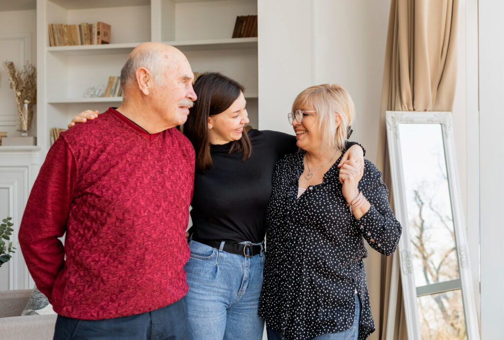 A happy woman standing with her parents