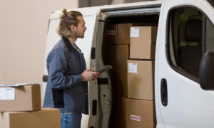 A male business owner with his delivery van, packed with boxes