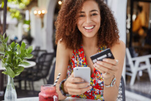 Happy female spending money on her credit card